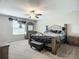 This primary bedroom features a ceiling fan, a sitting area, and a neutral color scheme at 1876 Colding Dr, Ruskin, FL 33570