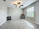 Bright bedroom with gray ceramic tile flooring, ceiling fan, and window with blinds at 1876 Colding Dr, Ruskin, FL 33570