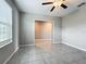 Bedroom with gray ceramic tile flooring, ceiling fan, and window with blinds at 1876 Colding Dr, Ruskin, FL 33570
