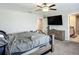 This primary bedroom features a ceiling fan, a TV, and a neutral color scheme at 1876 Colding Dr, Ruskin, FL 33570