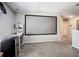 Bonus room with projector screen, carpeted floors and ample space at 1876 Colding Dr, Ruskin, FL 33570