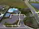 An aerial view of a community pool with lounge chairs, pool house, basketball court and manicured landscaping at 1876 Colding Dr, Ruskin, FL 33570