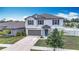 Two-story home boasts a well-maintained lawn, a two-car garage and a charming exterior at 1876 Colding Dr, Ruskin, FL 33570