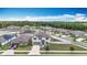 Light gray two-story home features a well-maintained lawn and landscaping in a suburban neighborhood setting under a bright sky at 1876 Colding Dr, Ruskin, FL 33570