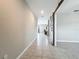 Hallway with gray ceramic tile flooring and a gray barn door, leading to the living areas at 1876 Colding Dr, Ruskin, FL 33570