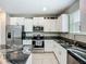 Updated kitchen featuring granite counters, stainless steel appliances, and white cabinets at 1876 Colding Dr, Ruskin, FL 33570