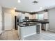 Modern kitchen featuring white cabinets, granite countertops, stainless appliances, and an island at 1876 Colding Dr, Ruskin, FL 33570