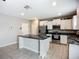 Modern kitchen featuring white cabinets, stainless steel appliances, and a center island at 1876 Colding Dr, Ruskin, FL 33570