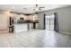 Open kitchen featuring an island, stainless steel appliances, granite counters, and ample natural light at 1876 Colding Dr, Ruskin, FL 33570
