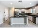 Kitchen featuring white cabinets, stainless steel appliances, an island with granite counter at 1876 Colding Dr, Ruskin, FL 33570