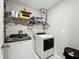 Well-organized laundry room with washer, dryer, and storage shelves to keep essentials in place at 1876 Colding Dr, Ruskin, FL 33570