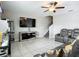 Modern living room featuring tiled floors, a ceiling fan, and wall mounted TV at 1876 Colding Dr, Ruskin, FL 33570