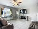 Bright living room featuring tiled floors, modern decor, and a large window at 1876 Colding Dr, Ruskin, FL 33570
