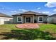 A pristine backyard with a patio, lush green grass and an inviting atmosphere, perfect for relaxation at 19041 Alfaro Loop, Spring Hill, FL 34610