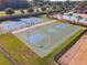 Aerial view of outdoor basketball and tennis courts in a fenced community recreation area at 19041 Alfaro Loop, Spring Hill, FL 34610