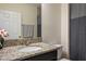 Modern bathroom featuring a granite vanity with a sink, mirror, and stylish striped shower curtain at 19041 Alfaro Loop, Spring Hill, FL 34610