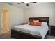Cozy bedroom with a dark wood bed frame, plush pillows, and neutral wall color creating a serene retreat at 19041 Alfaro Loop, Spring Hill, FL 34610