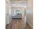 Hallway leads to a living room with wood flooring, neutral walls, and natural light at 19041 Alfaro Loop, Spring Hill, FL 34610