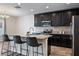 Bright, updated kitchen with island seating, black cabinets, and modern appliances at 19041 Alfaro Loop, Spring Hill, FL 34610
