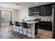 Stylish kitchen features sleek black cabinetry, granite countertops, stainless appliances, and a spacious center island at 19041 Alfaro Loop, Spring Hill, FL 34610