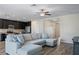 Open-concept living room with kitchen view, comfortable seating, and wood-look floors at 19041 Alfaro Loop, Spring Hill, FL 34610