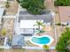 Aerial view of home featuring a heart-shaped pool, backyard, shed, and patio with a hot tub at 202 Cranberry Ln, Brandon, FL 33510