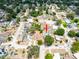 An aerial view shows a home with a private backyard pool nestled within a lush, tree-filled neighborhood at 202 Cranberry Ln, Brandon, FL 33510