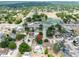 An aerial view of a home featuring a private pool and well-manicured lawns in a quiet neighborhood at 202 Cranberry Ln, Brandon, FL 33510