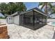 View of the backyard with the screened patio, pool, and privacy fence at 202 Cranberry Ln, Brandon, FL 33510