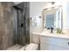 Modern bathroom with a sleek gray tile shower, updated vanity and fixtures at 202 Cranberry Ln, Brandon, FL 33510