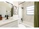 Stylish bathroom featuring a modern vanity, a large mirror, and shower with updated fixtures at 202 Cranberry Ln, Brandon, FL 33510
