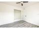 Bright bedroom with new flooring, ceiling fan, closet, and white walls offers a fresh, modern look at 202 Cranberry Ln, Brandon, FL 33510