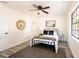 Charming bedroom featuring wood-look floors, ceiling fan, and updated window at 202 Cranberry Ln, Brandon, FL 33510