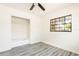 Comfortable bedroom featuring a built-in closet with drawers, a ceiling fan, and new window at 202 Cranberry Ln, Brandon, FL 33510