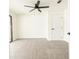 Bright, carpeted bedroom with a black ceiling fan, white walls, and natural light from a sliding glass door at 202 Cranberry Ln, Brandon, FL 33510