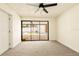 Bedroom with new carpet, black ceiling fan, and view of a screened lanai and pool through sliding glass doors at 202 Cranberry Ln, Brandon, FL 33510