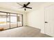 Bright bedroom with new carpet, ceiling fan, and slider leading to an outdoor patio, enhancing the living space at 202 Cranberry Ln, Brandon, FL 33510