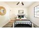 Bright bedroom showcases a modern black metal bed frame and stylish decor at 202 Cranberry Ln, Brandon, FL 33510