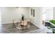 Charming dining area featuring a glass table, stylish chairs, and wood-look flooring at 202 Cranberry Ln, Brandon, FL 33510