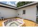 This backyard features a unique hot tub area and a doorway to the main house at 202 Cranberry Ln, Brandon, FL 33510