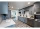 Bright kitchen features gray cabinetry, stainless appliances, white subway tile backsplash and modern countertops at 202 Cranberry Ln, Brandon, FL 33510