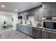 Bright kitchen features gray cabinetry, stainless appliances, white subway tile backsplash and modern countertops at 202 Cranberry Ln, Brandon, FL 33510