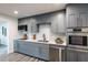 Bright kitchen features gray cabinetry, stainless appliances, white subway tile backsplash and modern countertops at 202 Cranberry Ln, Brandon, FL 33510