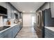 Modern kitchen with stainless steel appliances, subway tile backsplash, and sleek gray cabinets at 202 Cranberry Ln, Brandon, FL 33510