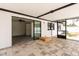 Covered, stone-paved lanai with views into the connected interior space and the outdoor pool and yard at 202 Cranberry Ln, Brandon, FL 33510