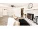 Living room features a decorative fireplace, chairs, area rug, ceiling fan and open concept at 202 Cranberry Ln, Brandon, FL 33510