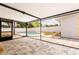 View of the backyard patio, pool, and landscaping from inside the screened lanai at 202 Cranberry Ln, Brandon, FL 33510