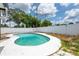 Wide angle shot of the in-ground pool surrounded by a white concrete deck and privacy fence at 202 Cranberry Ln, Brandon, FL 33510