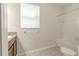 A full bathroom offers a vanity, window, and a shower/tub combo at 20404 Autumn Fern Ave, Tampa, FL 33647
