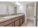 Bright bathroom featuring a double vanity, neutral countertops, and tiled floors at 20404 Autumn Fern Ave, Tampa, FL 33647